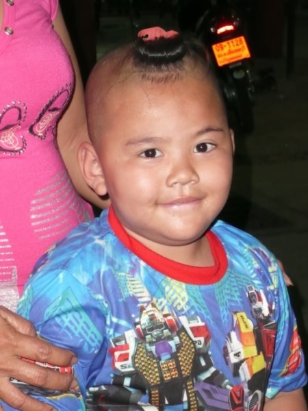 Adorable little boy with his hair cut in the old traditional style