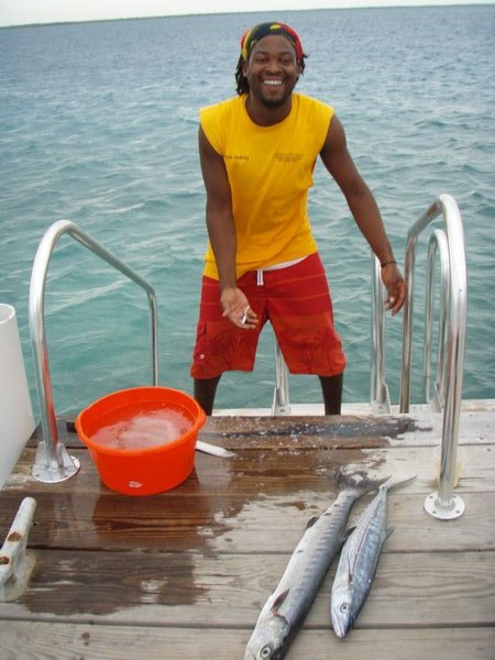Captain Jermaine filleting the days catch for dinner