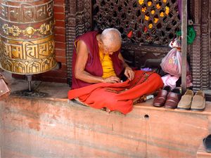Buddhist monk making offerings