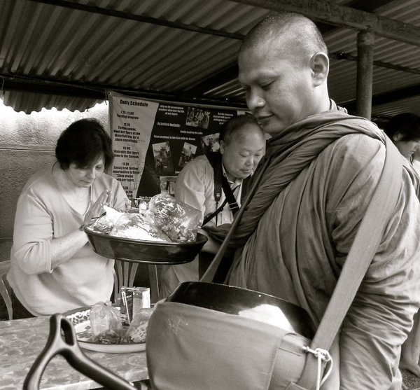 Giving alms to Monks