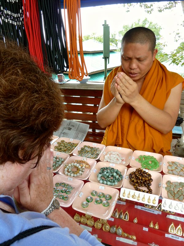 Monk giving me blessing holding my necklace