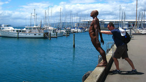 Kip tries to push the statue into the water