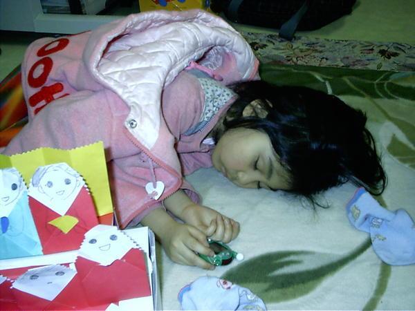 Lina sleeping with her tamagochi
