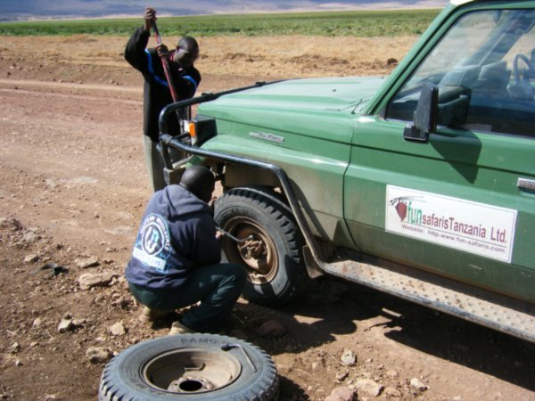 Fixing a flat tyre in the crater
