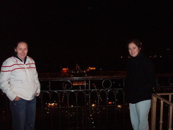 Ash and I standing on the Eiffel Tower with some famous monument in the background