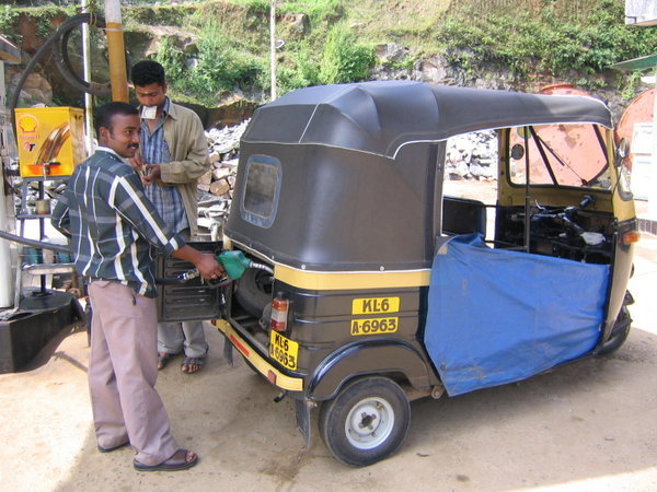 Saneesh, my spice and tea tour guide, fills up his rickshaw