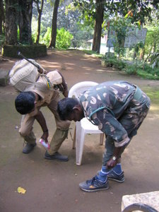 Our guide and gunman apply tobacco powder to their leech socks, before we head out on the first day.