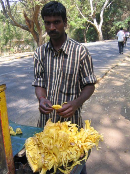 Jack fruit vendor removing the fruit from the peel