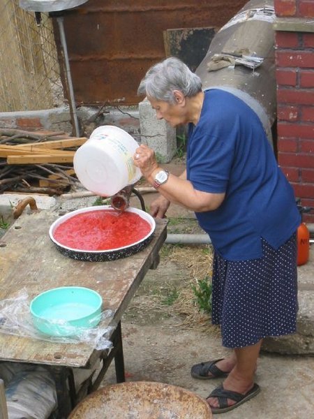 Mama making tomato paste
