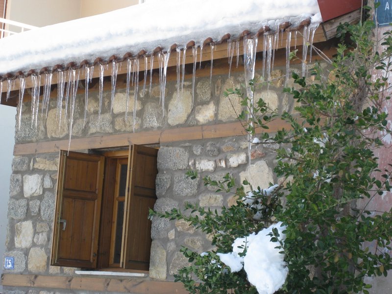 Icicles on hewn stone house, Florina