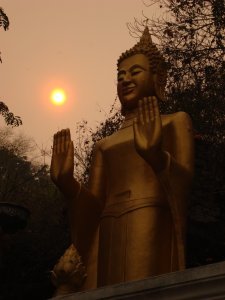 Smoky Sunset over a Golden Buddha