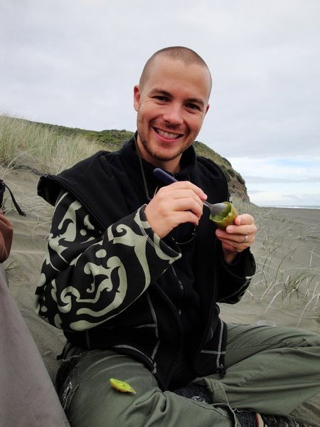 Eating a kiwi on a kiwi beach