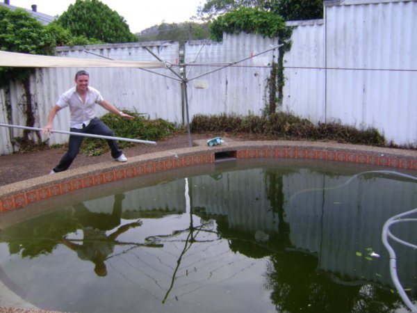 Aussie James tries to harpoon a frog in Karl's swampy pool