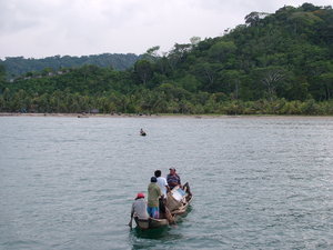 Locals transporting filing cabinet via canoe