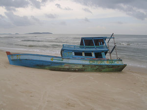 Abandoned boat on the mainland beach