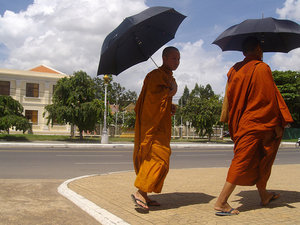 Monks walking past the Royal Palace gates