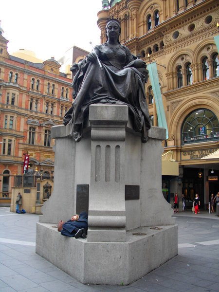 Statue of Queen Victoria outside the building of the same name in Sydney. Complete with sleeping tramp