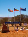 Driving into Hermannsburg. The three flags, from left are Northern Territory, Aboriginal and Australian