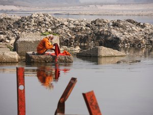 A sadhu washing his clothes in the Ganges
